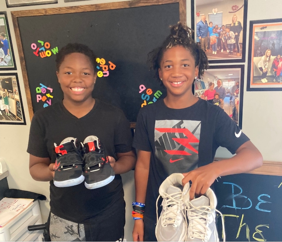 Happy Kids Holding Shoes